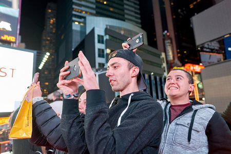 NEW YORK - CIRCA MARCH, 2016: people taking photos in New York at nighttime. The City of New York, often called New York City or simply New York, is the most populous city in the United Statesのeditorial素材