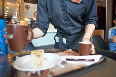SHENZHEN, CHINA - MAY 06, 2016: barista bring order at McCafe. McCafe is a coffee house style food and drink chain, owned by McDonald's.のeditorial素材