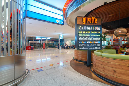 DUBAI, UAE - MARCH 09, 2016: inside of Dubai International Airport. There are a lot of restaurants, bars, cafes and shops in Dubai International Airport. Almost all of them are open twenty-four hours.のeditorial素材