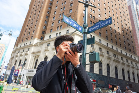 NEW YORK - CIRCA MARCH, 2016: man taking photos in New York. The City of New York, often called New York City or simply New York, is the most populous city in the United Statesのeditorial素材