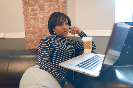 NEW YORK - CIRCA MARCH, 2016: woman with computer in the hostel. Hostels provide budget-oriented, sociable accommodation where guests can rent a bed, usually a bunk bed, in a dormitory and share a bathroom, lounge, and sometimes a kitchen.のeditorial素材