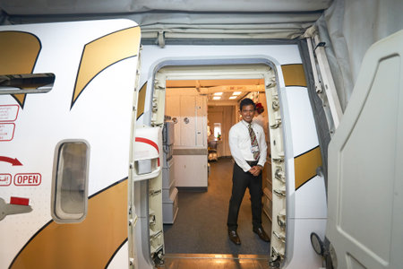 DUBAI, UAE - MARCH 09, 2016: Emirates crew member meet passengers on board of Boeing 777. Emirates is one of two flag carriers of the United Arab Emirates along with Etihad Airways and is based in Dubai.のeditorial素材