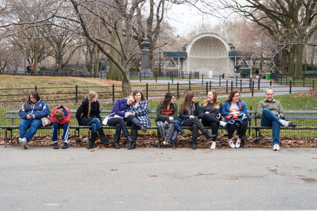 NEW YORK - CIRCA MARCH, 2016: people sit on the bench in Central Park. Central Park is an urban park in middle-upper Manhattan, within New York City.のeditorial素材