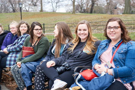 NEW YORK - CIRCA MARCH, 2016: people sit on the bench in Central Park. Central Park is an urban park in middle-upper Manhattan, within New York City.のeditorial素材