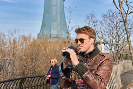 NEW YORK - CIRCA MARCH, 2016: man taking photos in New York. The City of New York, often called New...