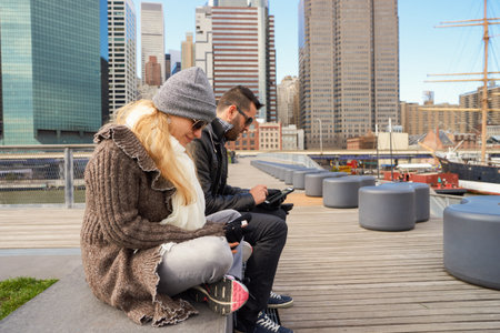 NEW YORK - MARCH 17, 2016: couple at Pier 15 at daytime. Pier 15 is located east of South Street and FDR Drive in Lower Manhattan, New York City.のeditorial素材