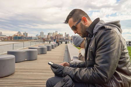 NEW YORK - MARCH 17, 2016: couple at Pier 15 at daytime. Pier 15 is located east of South Street and FDR Drive in Lower Manhattan, New York City.のeditorial素材