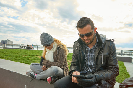 NEW YORK - MARCH 17, 2016: couple at Pier 15 at daytime. Pier 15 is located east of South Street and FDR Drive in Lower Manhattan, New York City.のeditorial素材