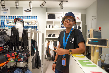 KUALA LUMPUR, MALAYSIA - MAY 09, 2016: portrait of seller in Adidas store in Suria KLCC. Suria KLCC is a shopping mall is located in the Kuala Lumpur City Centre district. It is in the vicinity of the landmark the Petronas Towers.のeditorial素材