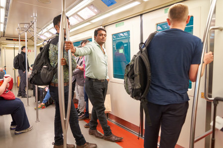 DUBAI, UAE - MARCH 09, 2016: passengers in the train at Dubai International Airport. Dubai International Airport is the primary airport serving Dubai, United Arab Emiratesのeditorial素材