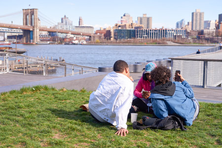 NEW YORK - MARCH 17, 2016: people take a rest at Pier 15 at daytime. Pier 15 is located east of South Street and FDR Drive in Lower Manhattan, New York City.のeditorial素材