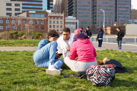 NEW YORK - MARCH 17, 2016: people take a rest at Pier 15 at daytime. Pier 15 is located east of South Street and FDR Drive in Lower Manhattan, New York City.のeditorial素材