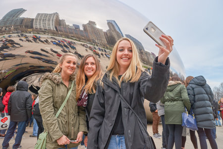 CHICAGO, IL - CIRCA MARCH, 2016: woman taking a selfie near Cloud Gate. Cloud Gate is a public...