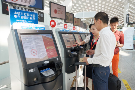 SHENZHEN, CHINA - CIRCA MAY, 2016: man use self check-in kiosk in Shenzhen Bao'an International...