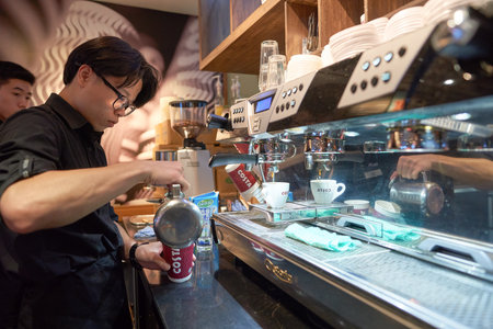 SHENZHEN, CHINA - CIRCA MAY, 2016: barista in Costa Coffee. Costa Coffee is a British multinational coffeehouse company. It is the second largest coffeehouse chain in the world behind Starbucks.のeditorial素材