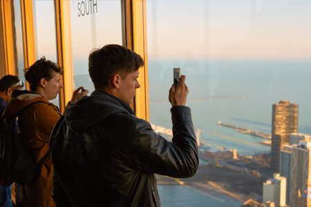 CHICAGO, IL - CIRCA MARCH, 2016: visitors at John Hancock Center's observatory. The John Hancock Center is a supertall skyscraper at 875 North Michigan Avenue, Chicago.のeditorial素材
