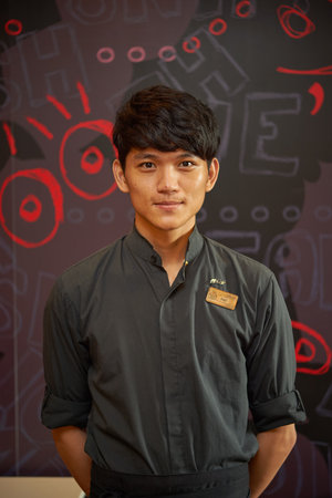 SHENZHEN, CNINA - JUNE 10, 2015: portrait of barista at McCafe. McCafe is a coffee-house-style food and drink chain, owned by McDonald'sのeditorial素材