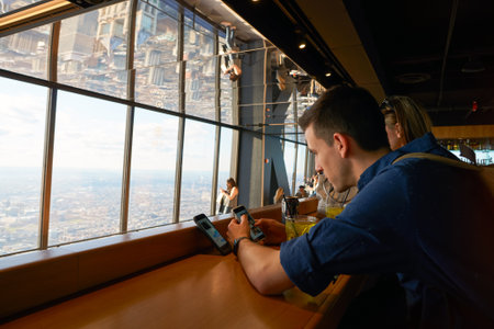 CHICAGO, IL - CIRCA MARCH, 2016: visitors at John Hancock Center's observatory. The John Hancock Center is a supertall skyscraper at 875 North Michigan Avenue, Chicago.のeditorial素材