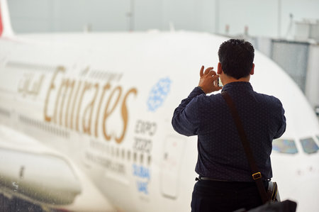 HONG KONG - MARCH 09, 2015: a man taking photo of docked Airbus A380. The Airbus A380 is a double-deck, wide-body, four-engine jet airliner.のeditorial素材