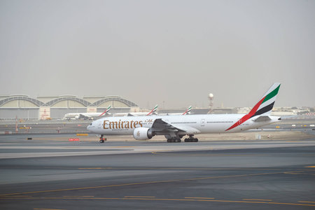 DUBAI, UAE - MARCH 10, 2015: Emirates Boeing 777 at Dubai International Airport. The Boeing 777 is a family of long-range wide-body twin-engine jet airliners developed and manufactured by Boeing Commercial Airplanes.のeditorial素材