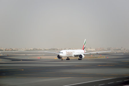 DUBAI, UAE - MARCH 10, 2015: Emirates Boeing 777 at Dubai International Airport. The Boeing 777 is a family of long-range wide-body twin-engine jet airliners developed and manufactured by Boeing Commercial Airplanes.のeditorial素材