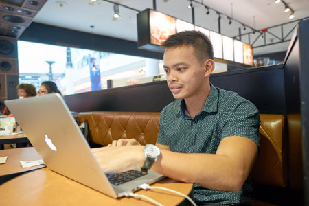 KUALA LUMPUR, MALAYSIA - MAY 09, 2016: indoor portrat of a man at Suria KLCC. Suria KLCC is located in the Kuala Lumpur City Centre district. It is in the vicinity of the landmark the Petronas Towers.のeditorial素材
