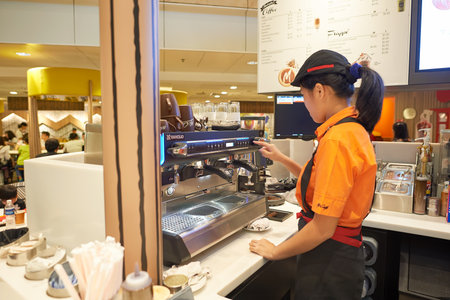 SINGAPORE - CIRCA NOVEMBER, 2015: barista in McCafe at Singapore Changi Airport. McCafe is a coffee-house-style food and drink chain, owned by McDonald'sのeditorial素材