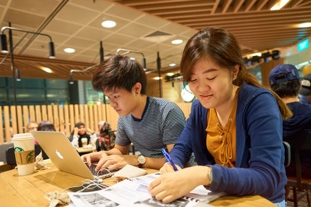 SINGAPORE - CIRCA AUGUST, 2016: people in Starbucks at Singapore Changi Airport. Starbucks Corporation is an American coffee company and coffeehouse chain.のeditorial素材