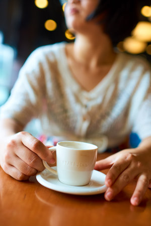 SHENZHEN, CHINA -  SEPTEMBER 07, 2016: a woman hold cup with espresso at Starbucks in Shenzhen. Starbucks Corporation is an American coffee company and coffeehouse chain.のeditorial素材