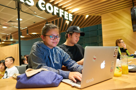 SINGAPORE - CIRCA AUGUST, 2016: people in Starbucks at Singapore Changi Airport. Starbucks Corporation is an American coffee company and coffeehouse chain.のeditorial素材