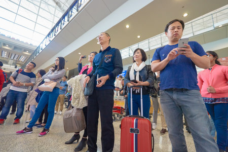 HONG KONG - DECEMBER 24, 2015: Magic perfomance audience at Hong Kong Airport. Hong Kong International Airport is the main airport in Hong Kong.のeditorial素材