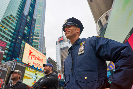 NEW YORK - CIRCA MARCH, 2016: outdoor portrait of NYPD officer at Times Square. The New York City...