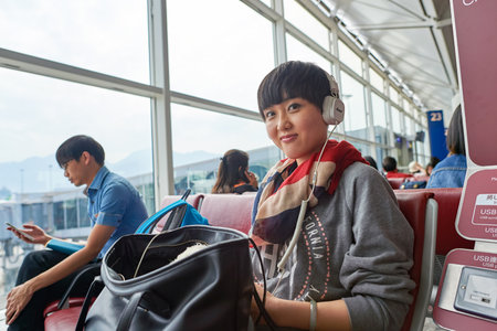 HONG KONG - NOVEMBER 03, 2015: indoor portrait of a woman at Hong Kong Airport. Hong Kong International Airport is the main airport in Hong Kong. It is located on the island of Chek Lap Kok.のeditorial素材