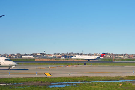 NEW YORK - APRIL 05, 2016: airplane at LaGuardia Airport. LaGuardia Airport is an international airport located in the northern part of Queens, New York City.のeditorial素材