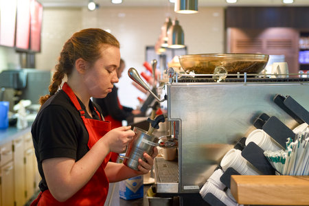 SAINT PETERSBURG, RUSSIA - 10 NOVEMBER, 2016: indoor portrait of a worker at Starbucks in Pulkovo Airport. Starbucks Corporation is an American coffee company and coffeehouse chain.のeditorial素材