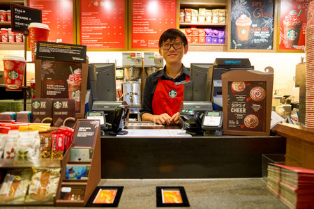 HONG KONG - CIRCA NOVEMBER, 2016: staff at a Starbucks cafe in Hong Kong. Starbucks Corporation is an American coffee company and coffeehouse chain.のeditorial素材