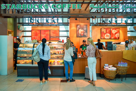 DUBAI - CIRCA NOVEMBER, 2016: a Starbucks cafe in Dubai International Airport. Starbucks Corporation is an American coffee company and coffeehouse chain.のeditorial素材