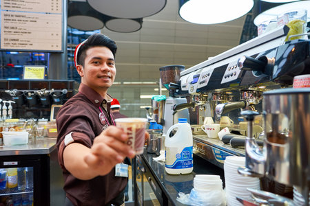 DUBAI, UAE - CIRCA NOVEMBER, 2016: barista at a Costa Coffee branch at Dubai international Airport. Costa Coffee is a British multinational coffeehouse company, it is the second largest coffeehouse chain in the world behind Starbucks and the largest in Brのeditorial素材