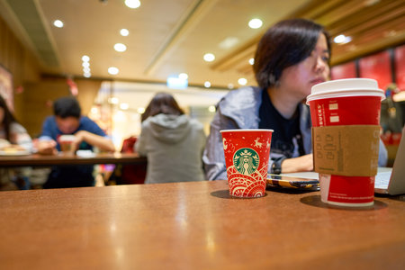 HONG KONG - CIRCA NOVEMBER, 2016: holiday cups at a Starbucks cafe in Hong Kong. Starbucks Corporation is an American coffee company and coffeehouse chain.のeditorial素材