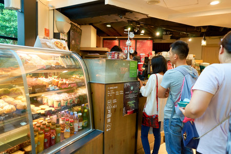 HONG KONG - CIRCA NOVEMBER, 2016: people at a Starbucks cafe in Hong Kong. Starbucks Corporation is...