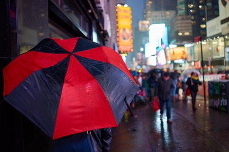 NEW YORK, NY - MARCH 14, 2016: a person with umbrella in New York City.のeditorial素材