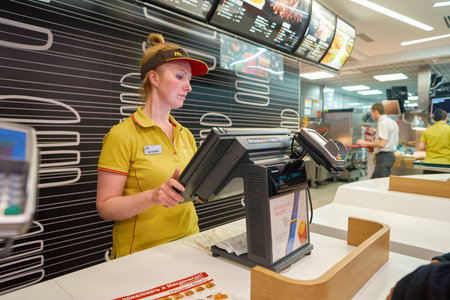 SAINT PETERSBURG, RUSSIA - CIRCA NOVEMBER, 2016: worker at McDonald's restaurant. McDonald's primarily sells hamburgers, cheeseburgers, chicken, french fries, breakfast items, soft drinks, milkshakes, dessertsのeditorial素材