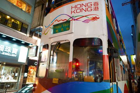 HONG KONG - CIRCA NOVEMBER, 2016: a double decker train in Hong Kong urban landscape at nighttime....