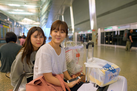 SINGAPORE - CIRCA NOVEMBER, 2015: indoor portrait of two women in MRT station at Changi Airport. MRT, is a rapid transit system forming the major component of the railway system in Singapore.のeditorial素材