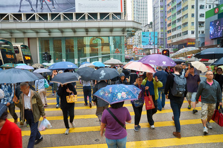 HONG KONG - CIRCA NOVEMBER, 2016: people walking on Hong Kong street at rainy dayのeditorial素材