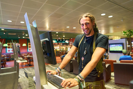 SINGAPORE - CIRCA AUGUST, 2016: man use free internet access cumputer at Singapore Changi Airport....