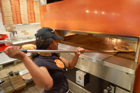 CHICAGO, IL - CIRCA MARCH, 2016: worker cook pizza at Blaze Pizza restaurant. Blaze Pizza LLC is a Pasadena, California-based chain within the fast-casual dining restaurants category.のeditorial素材