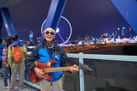 HONG KONG - CIRCA DECEMBER, 2015: an elder man play on guitar