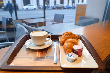 GENEVA, SWITZERLAND - CIRCA NOVEMBER, 2015: tray with coffee and croissantes at McCafe in Geneva. McCafe is a coffee-house-style food and drink chain, owned by McDonald's.のeditorial素材