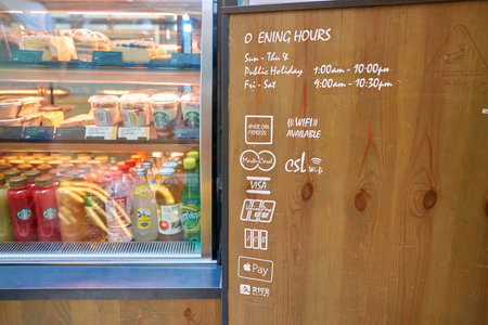 HONG KONG - CIRCA SEPTEMBER, 2016: display case, schedule and credit card network logos at Starbucks coffee shop in Hong Kong.のeditorial素材